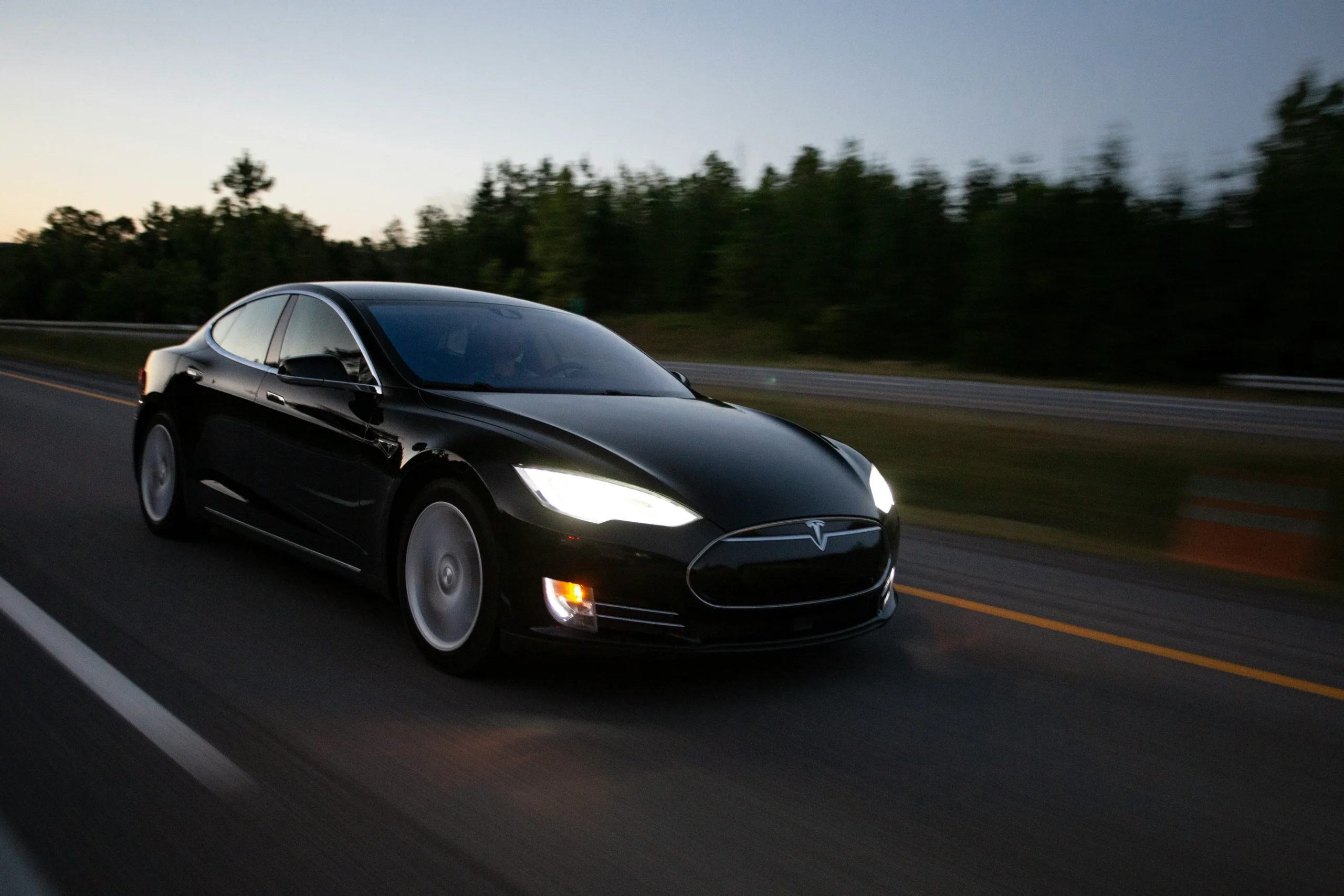 Tesla Model S and Model 3 racing on a track, highlighting their acceleration and performance differences